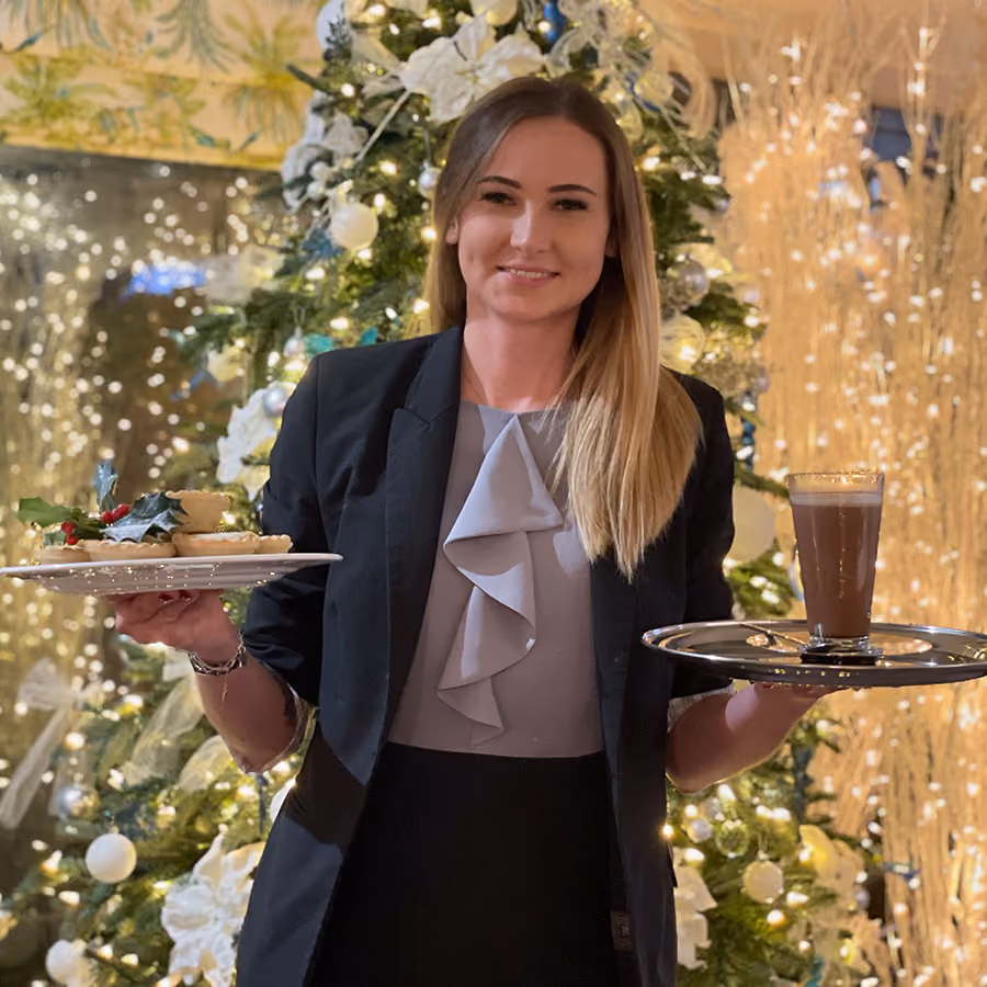 Hotel staff serving food and drink at Christmas