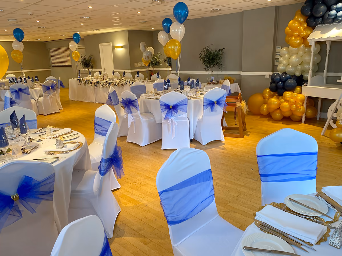 Blue and gold line the ballroom for this classy wedding reception.