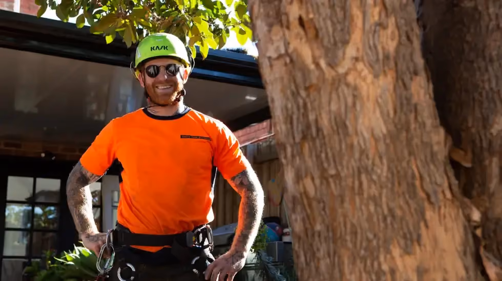 One of our arborists smiling for the camera while working at a client’s home.