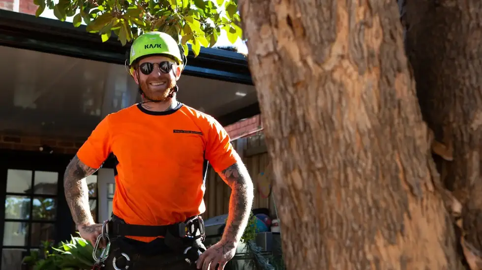 One of our arborists smiling for the camera while working at a client’s home.
