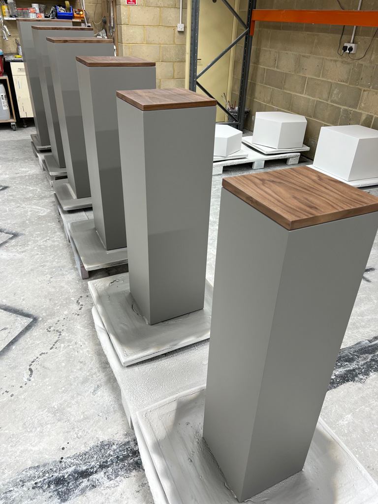 white and wood nesting plinths