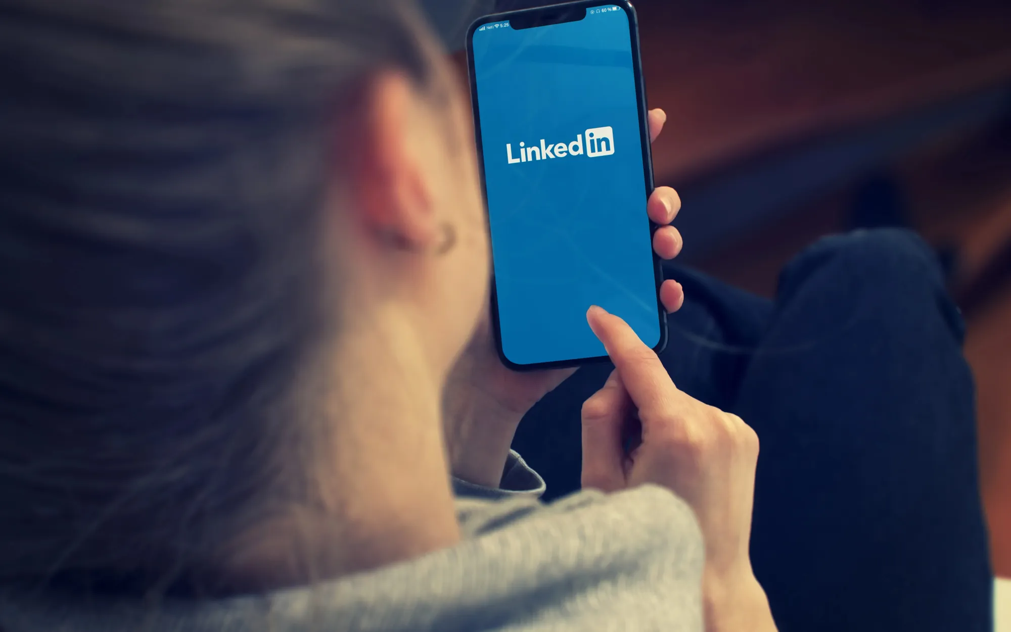 Person using the LinkedIn mobile app for professional networking, social media outreach, and business marketing