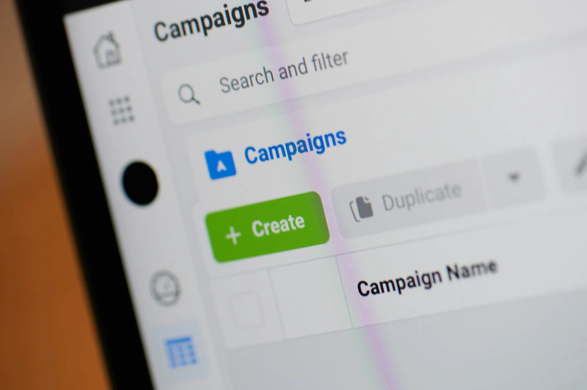 Close-up of a digital marketing dashboard screen showing the Campaigns section with a green Create button