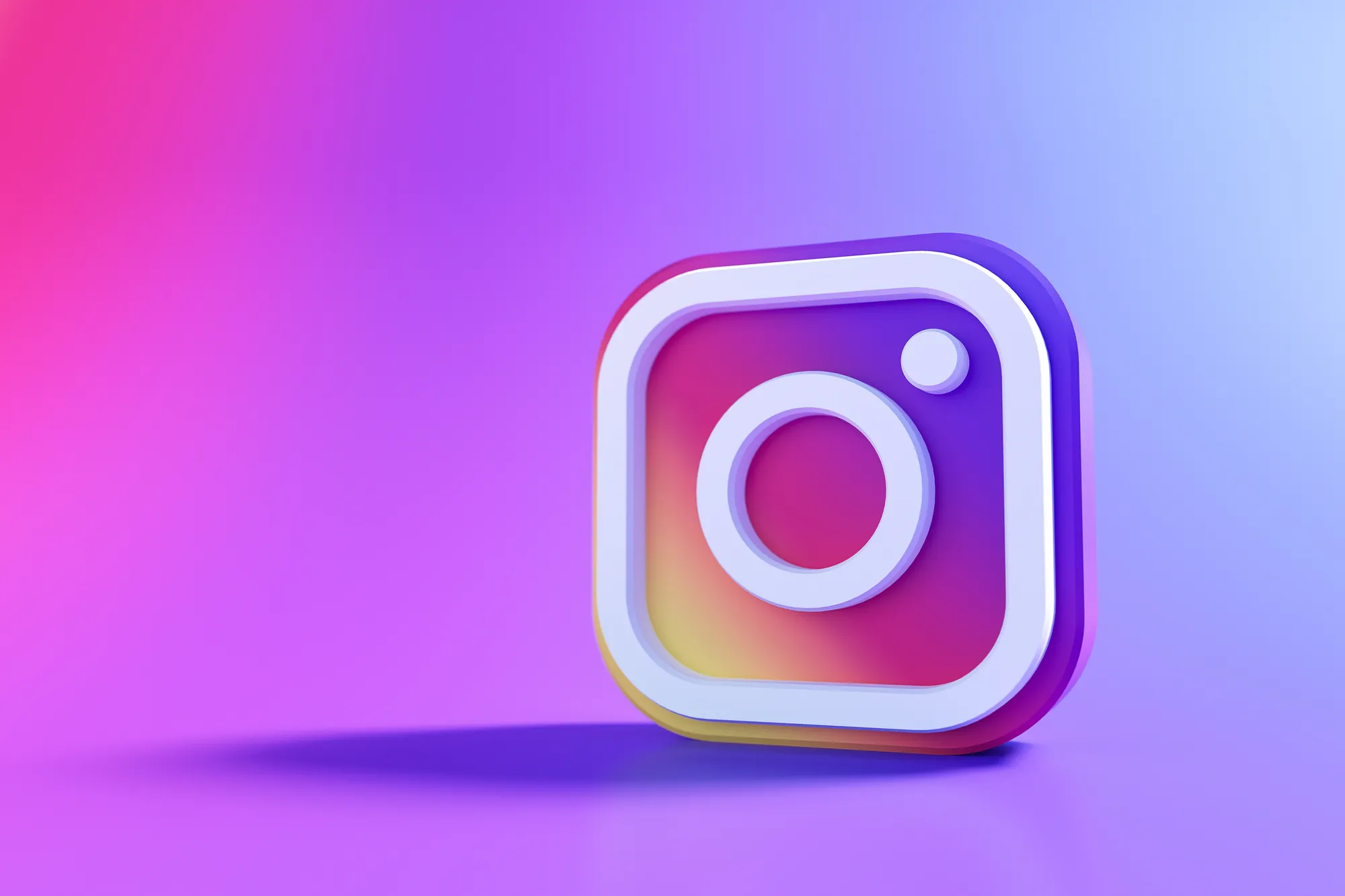 3D rendering of the Instagram camera logo icon against a pink and purple gradient background