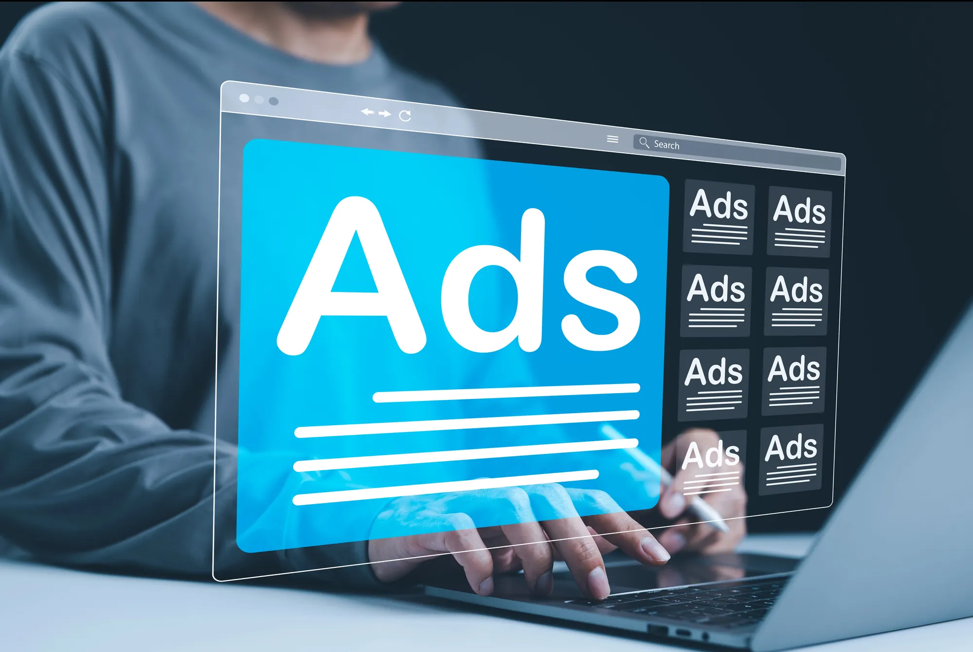 Person typing on a laptop with a digital overlay of a browser window displaying the word Ads and a grid of ad placements