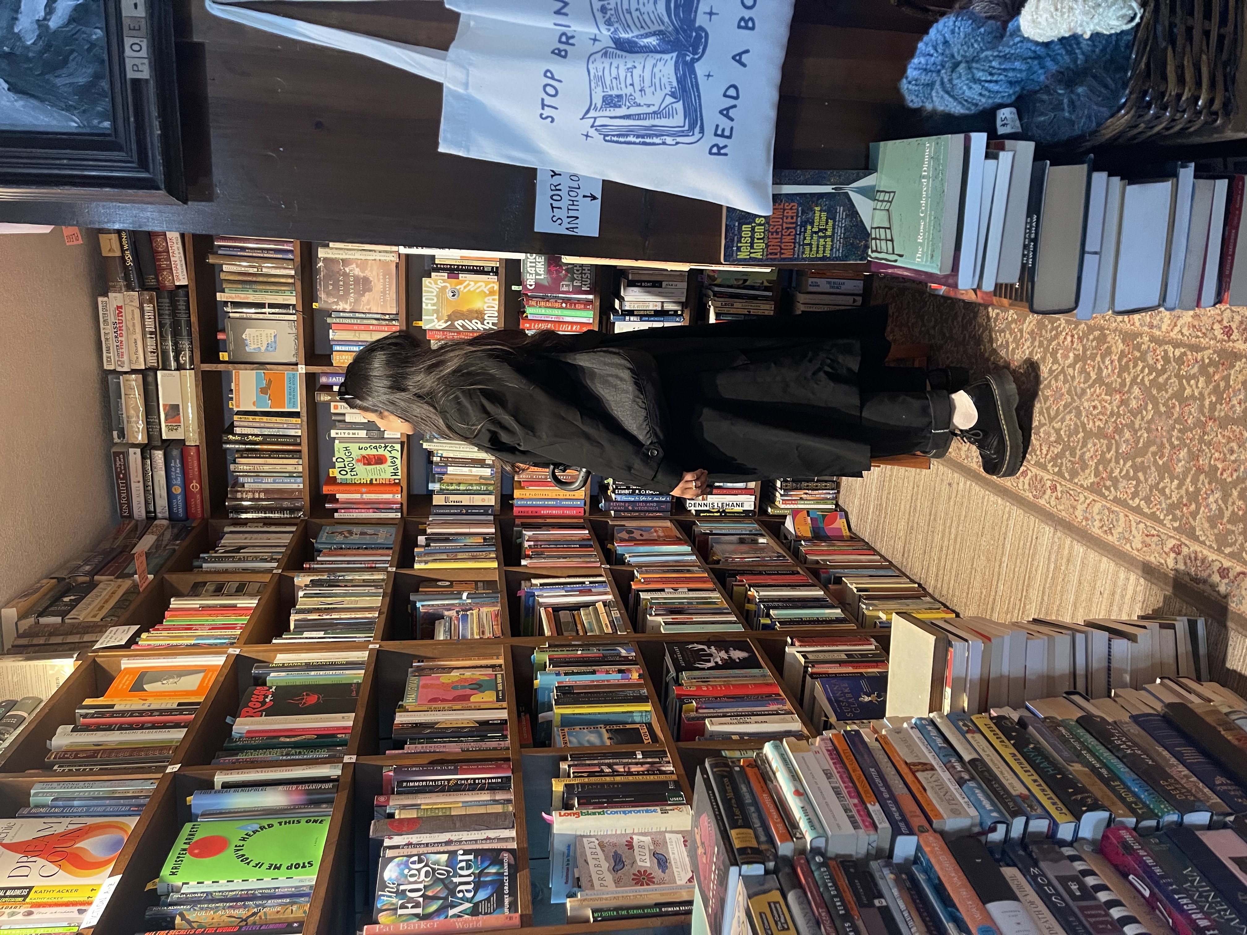 Kayla standing in between shelves at a bookstore