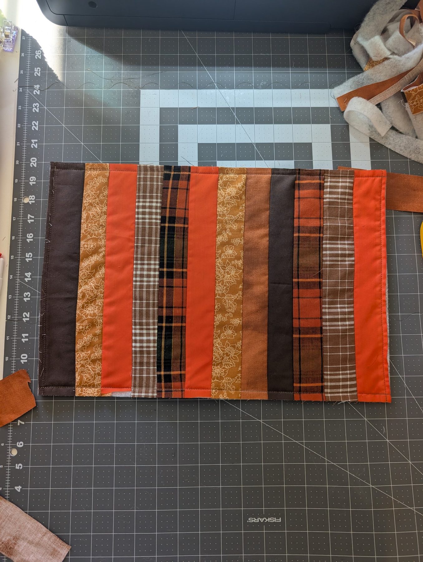 Quilted plaid table runner on a cutting mat