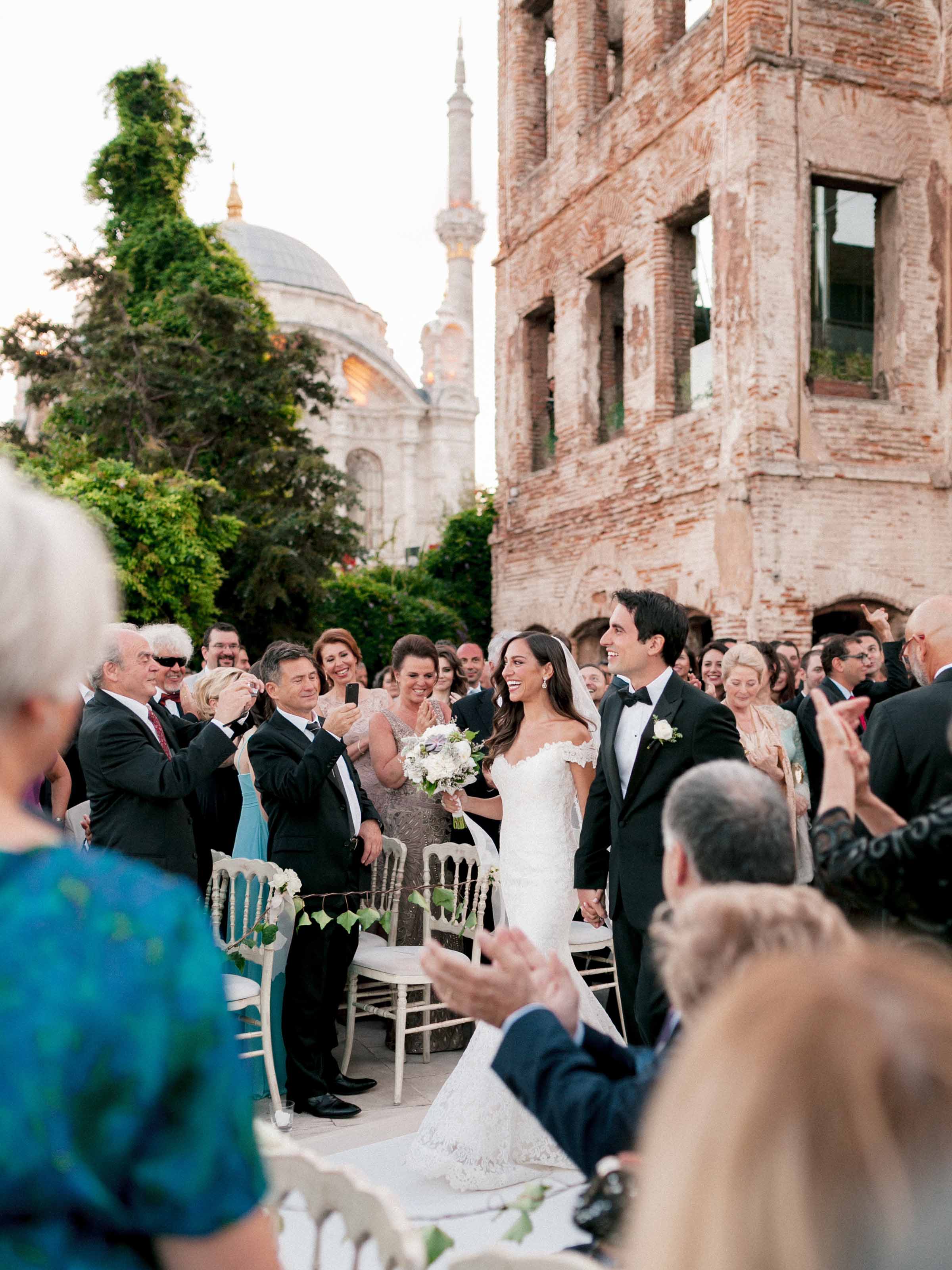 Outdoor ceremony before a historic brick facade and minaret, Esma Sultan Yalısı, Istanbul