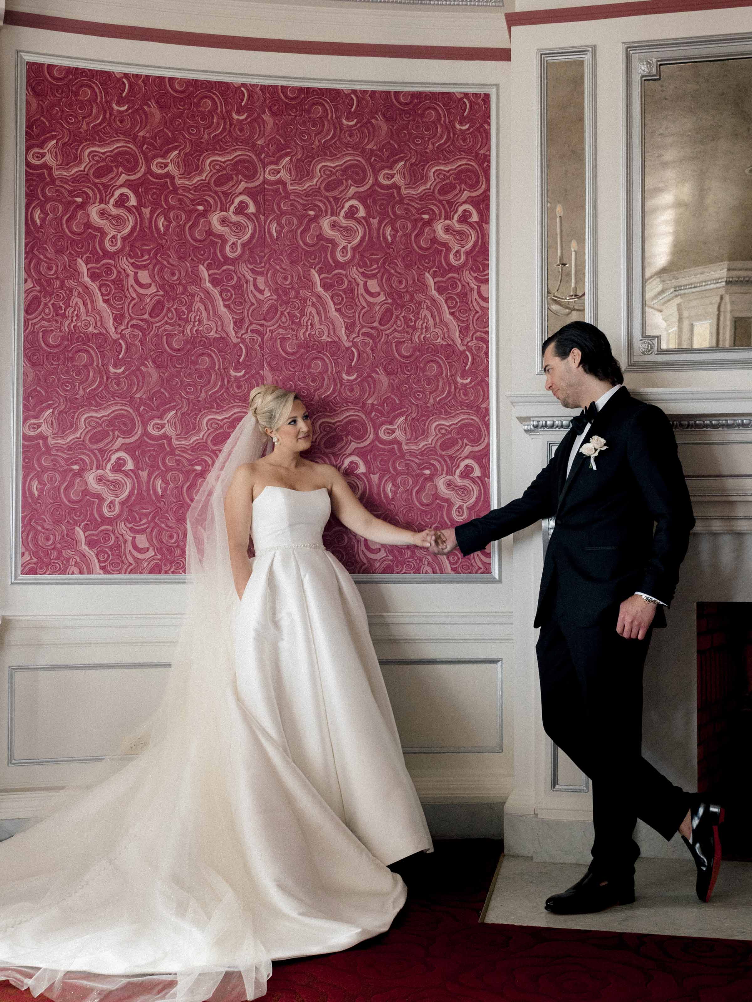 Groom stepping toward his bride in a papered drawing room, Fairmont Le Château Frontenac, Québec City