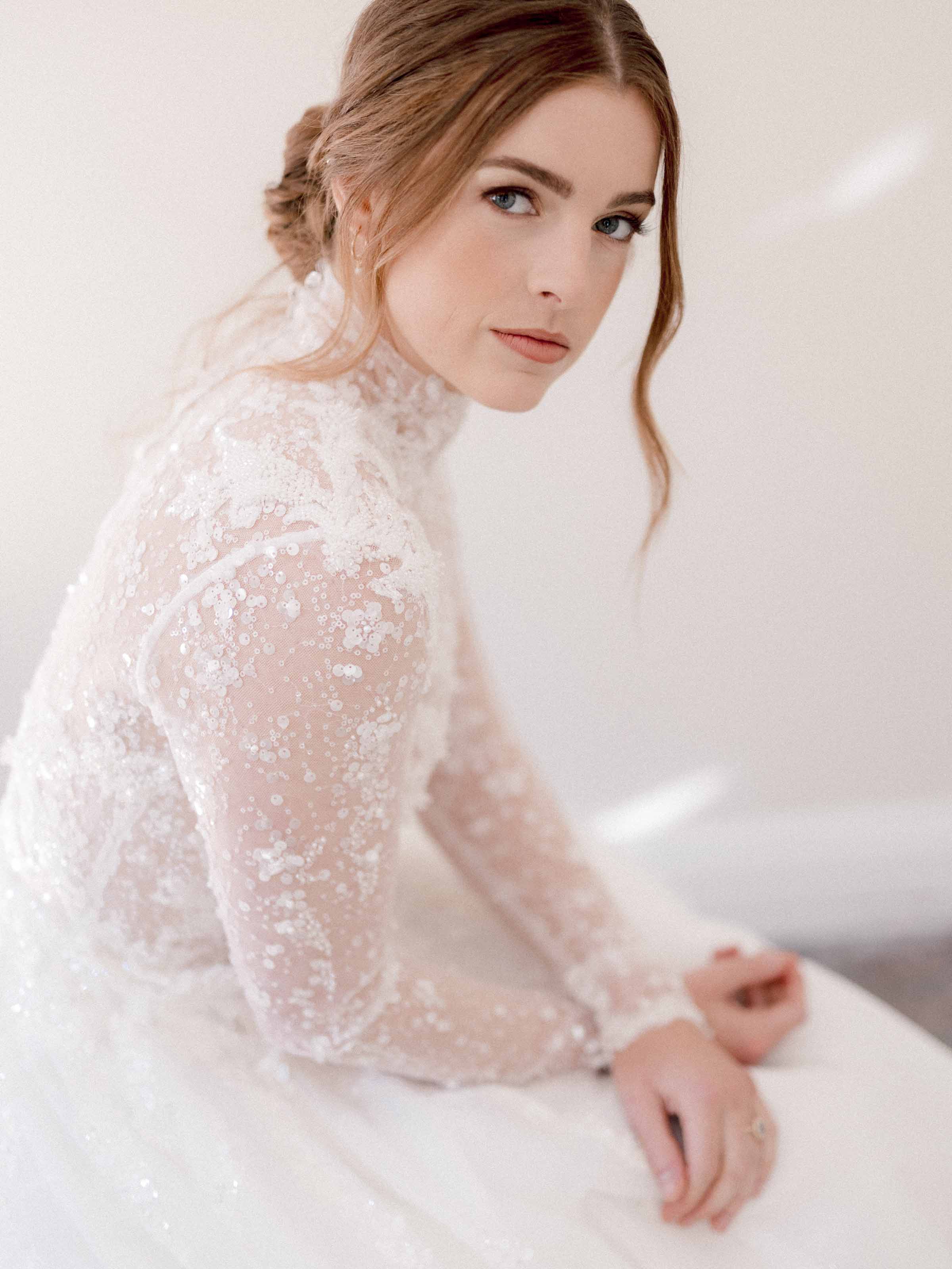 Bride seated in a lace gown looking over her shoulder, Montreal