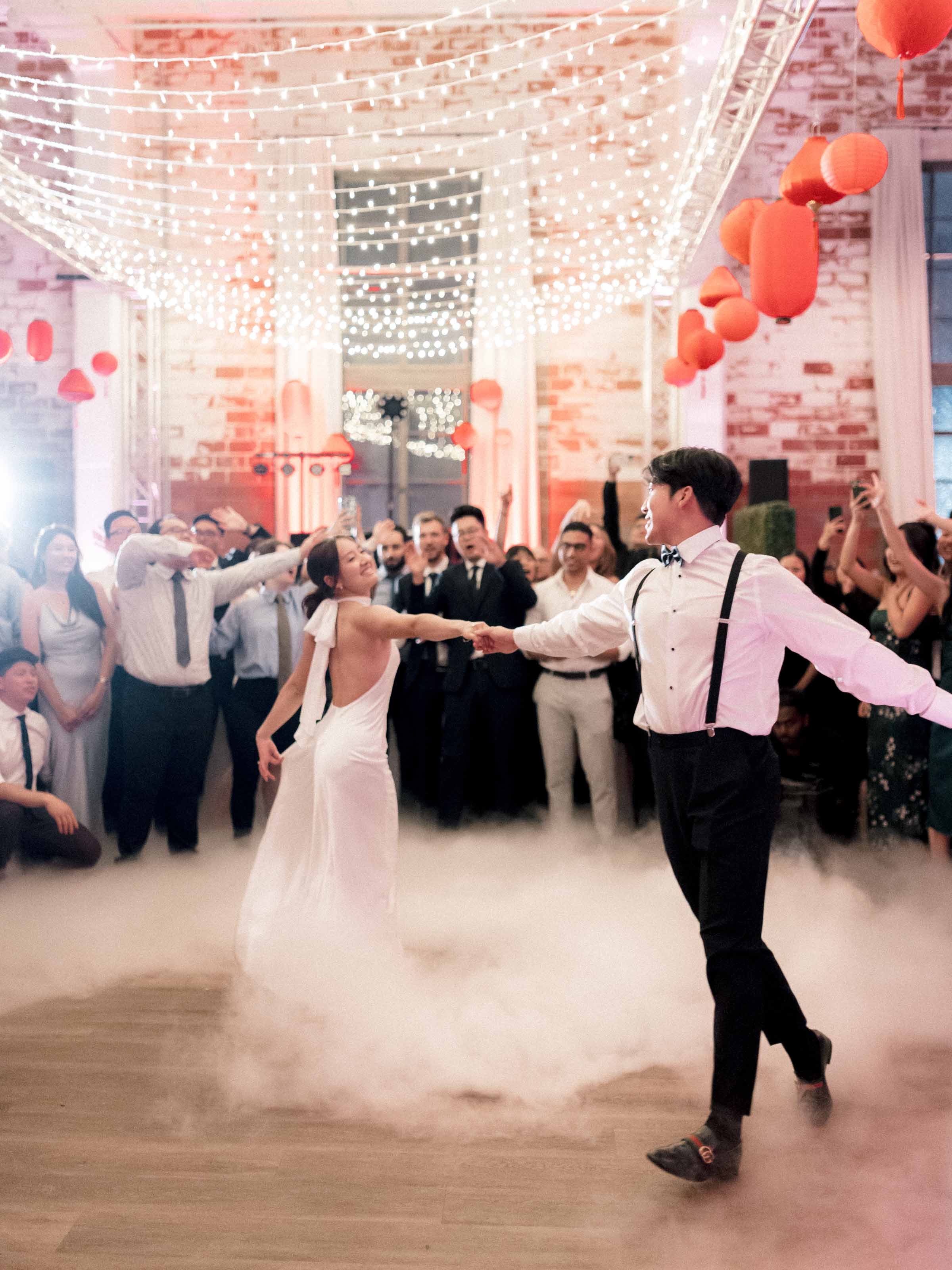 First dance in low fog beneath festoon lights and balloons, Montréal