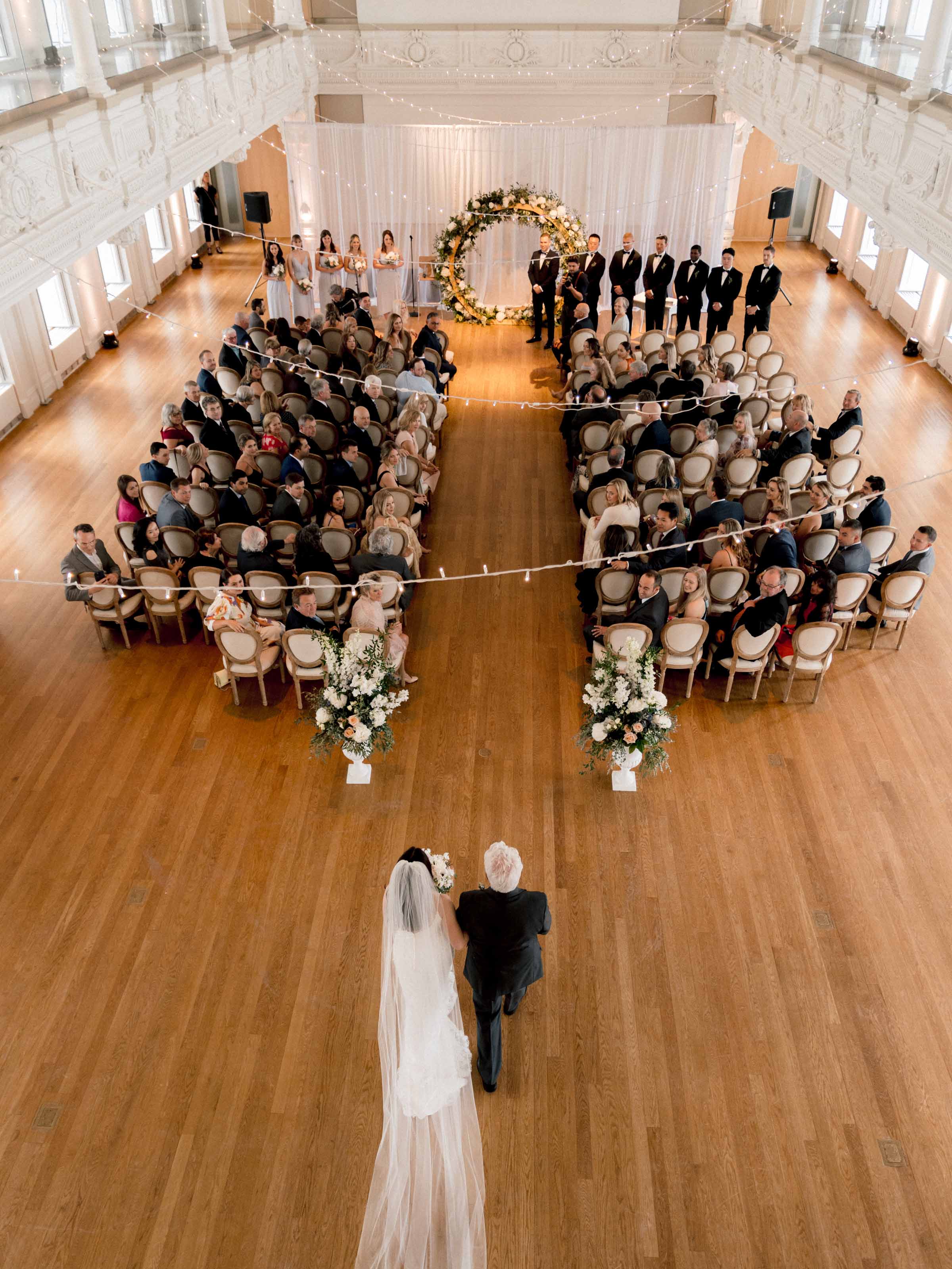 Vue en plongée de la mariée marchant dans l'allée entre les invités assis, Québec