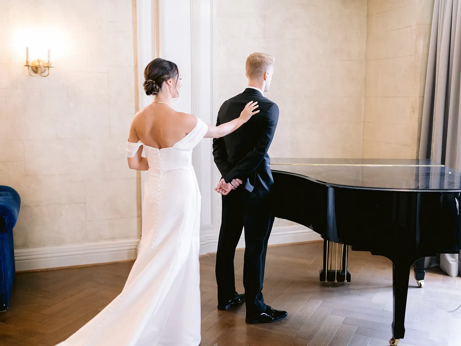 First look beside a grand piano in a salon at the Chateau Frontenac