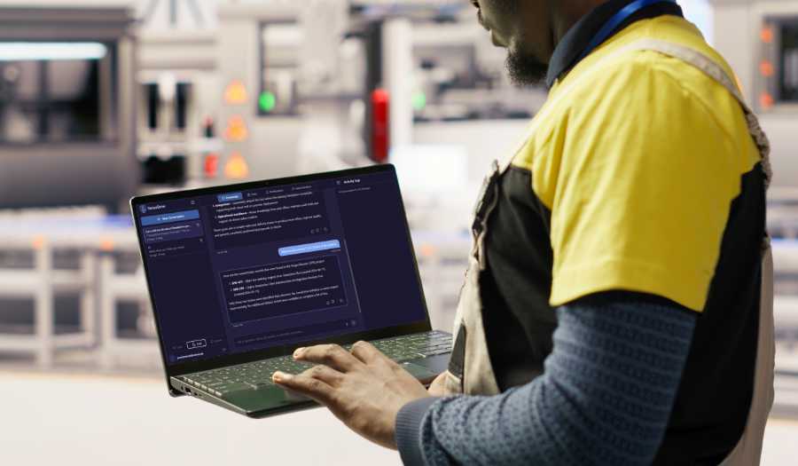 Man using SABO SenseDrive.ai knowledge management tool in a modern factory on a laptop.