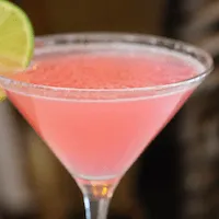 cosmopolitan cocktail with a lime wheel