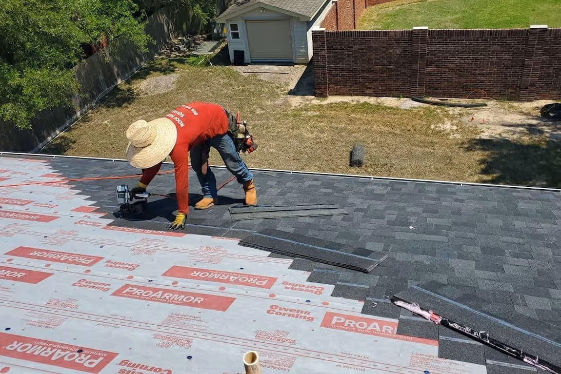 worker on top of roof