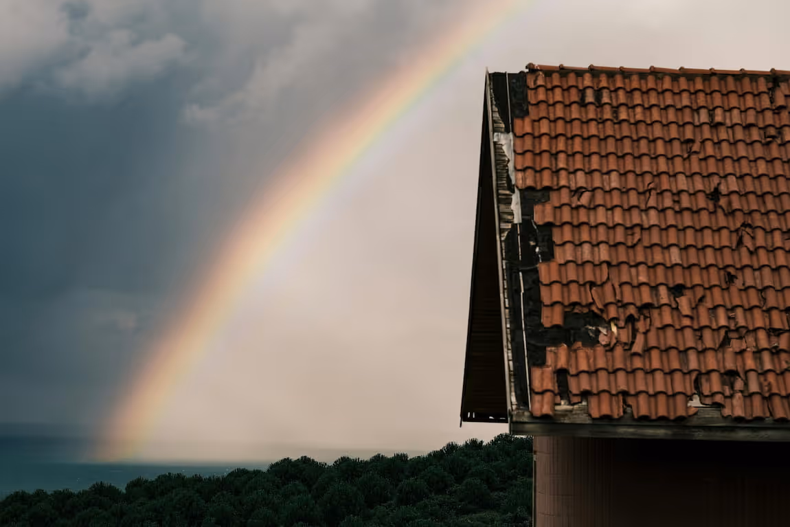 a house with a rainbow as background