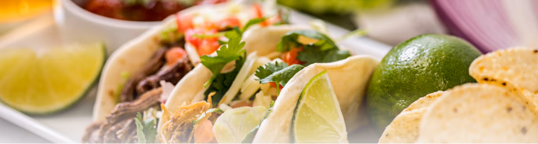 Bright and airy street tacos with lime on a table
