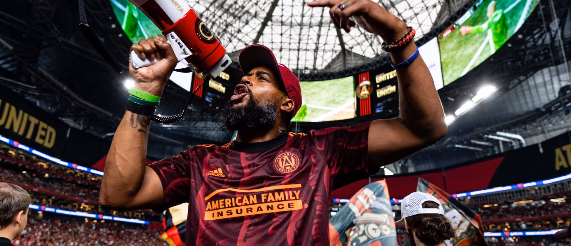 Atlanta United fan screaming and hyping up other fans