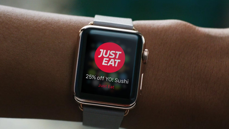 Smartwatch on wrist showing Just Eat notification for 25% off YO! Sushi offer.
