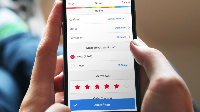 Smartphone screen showing food delivery app filter options including cuisine, store hours, timing, and user reviews.