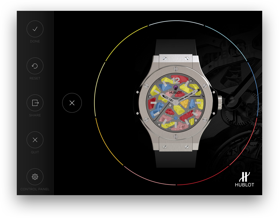Hublot wristwatch with a colorful, abstract dial design and black strap on a black background.