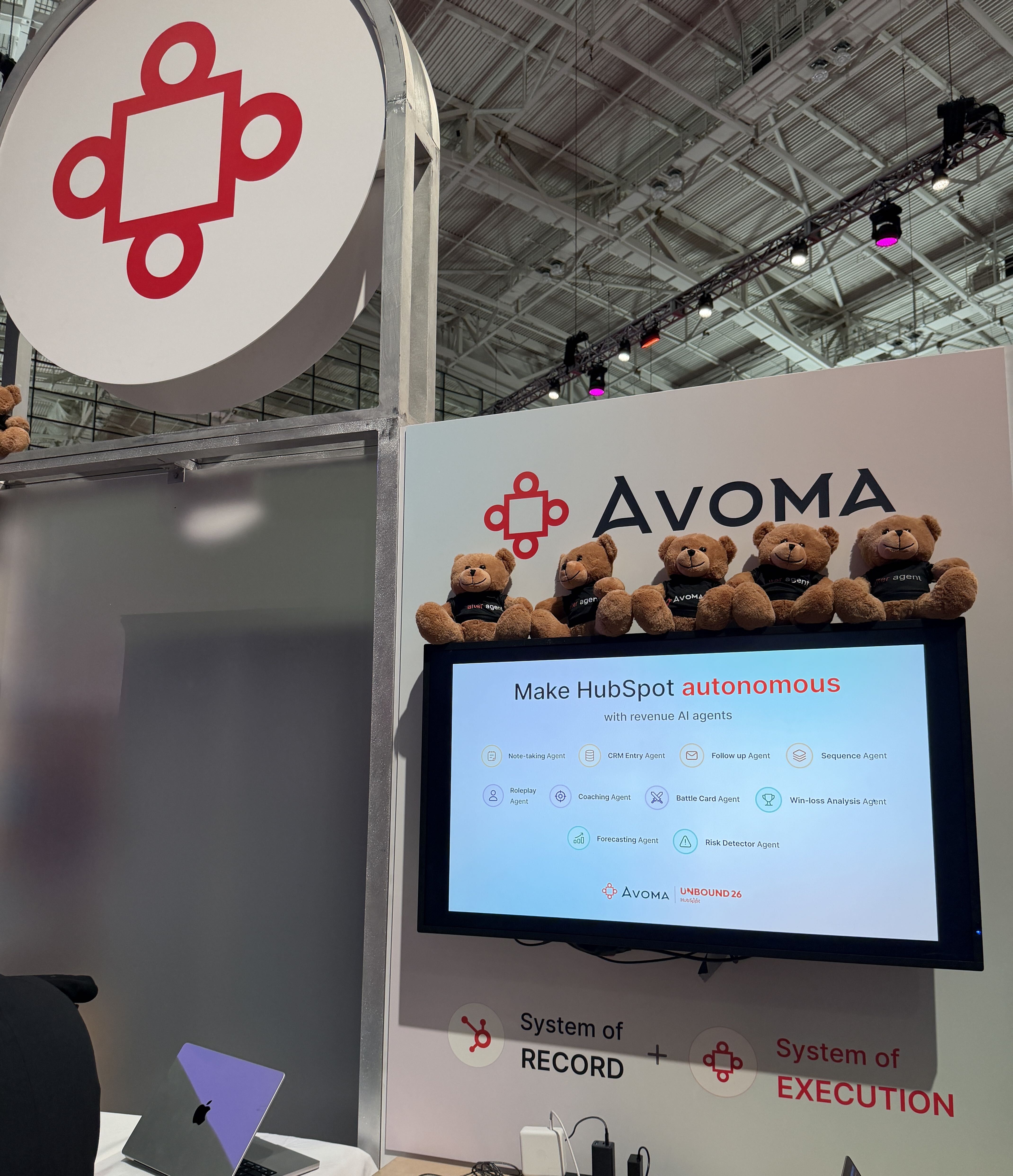The Avoma team at the UNBOUND 2026 booth in front of the bear display