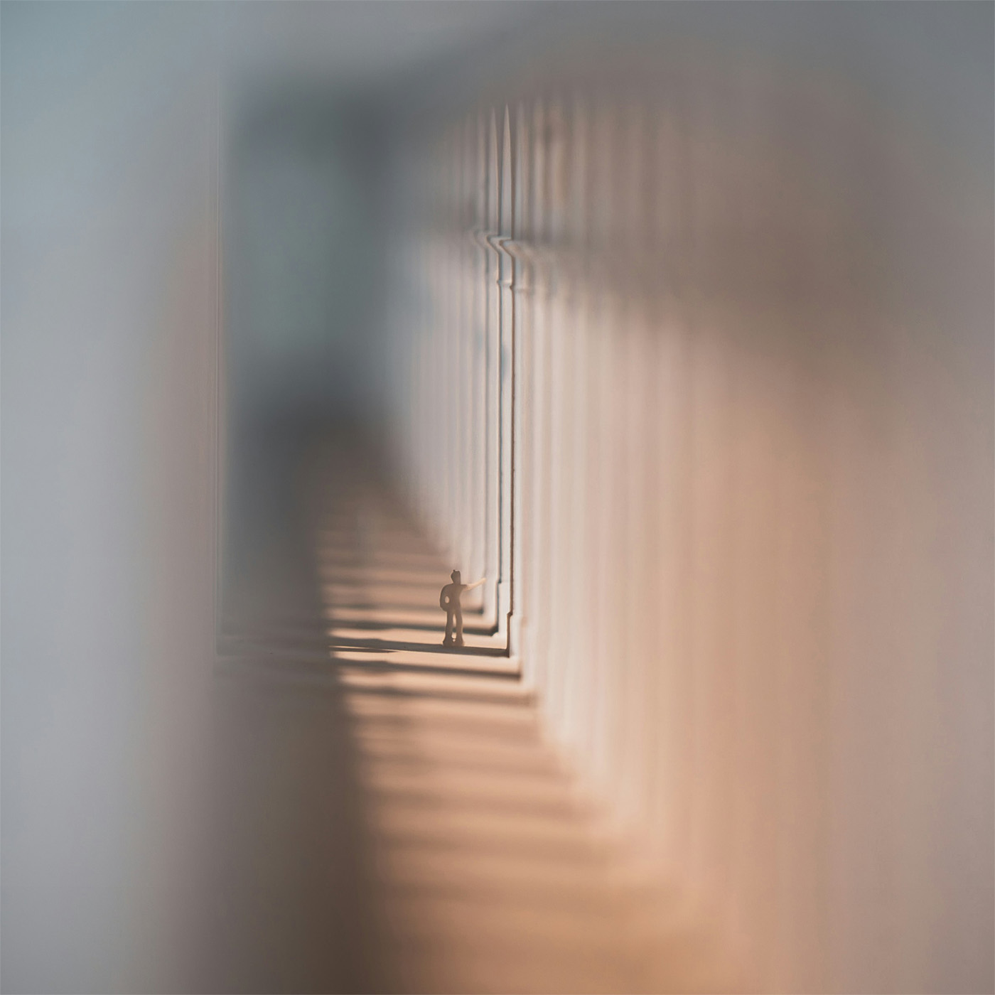 small toy man walking down blurred dreamlike tunnel