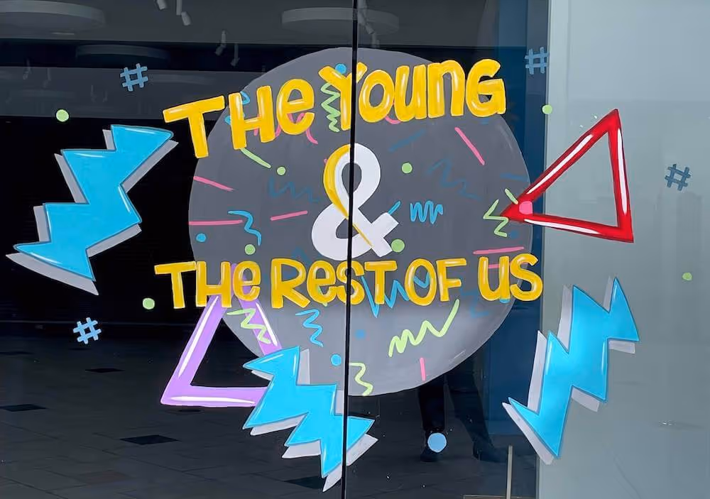 The Young & The Rest of Us painted in window paint 