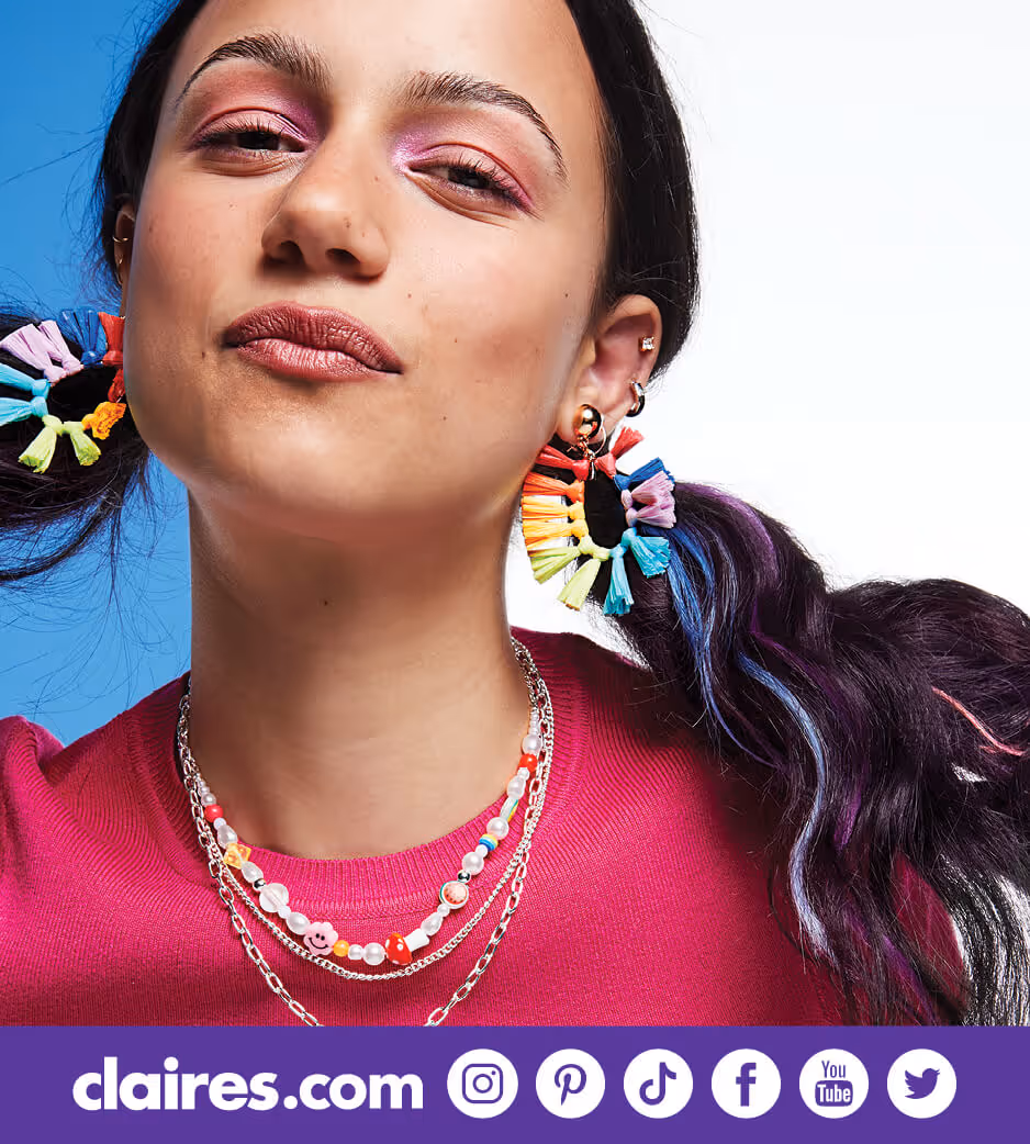 Young woman rainbow earrings and colorful necklace