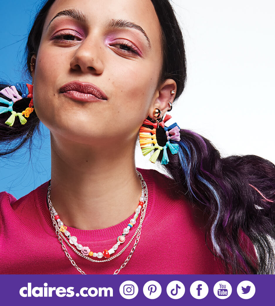 Young woman rainbow earrings and colorful necklace