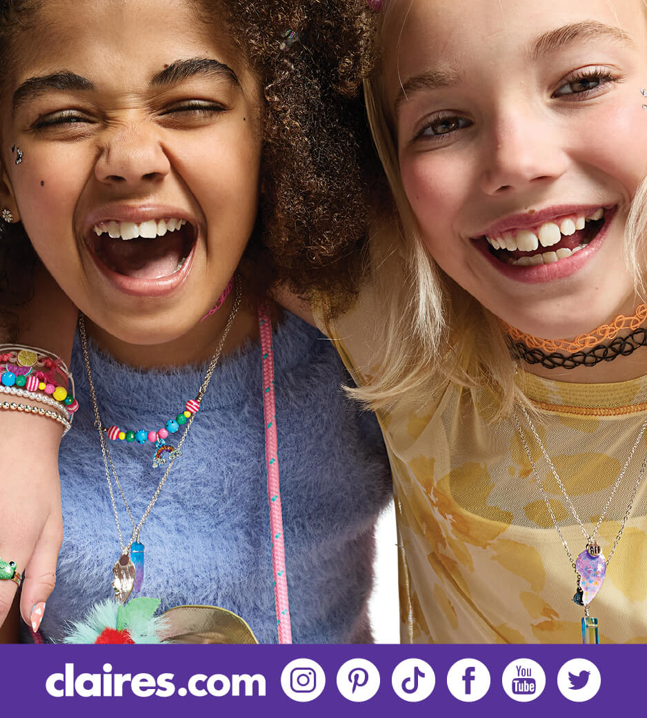 Two young girls with a variety of colorful accessories