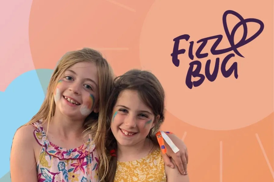 Two young girls with face paint smiling against a colorful backdrop with 'Fizz Bug' text and logo.