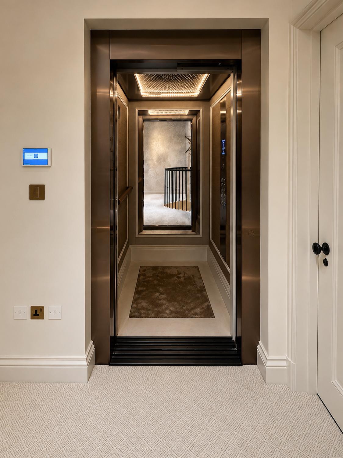 Open modern home lift with mirrored interior and beige carpeted floor in a white hallway.
