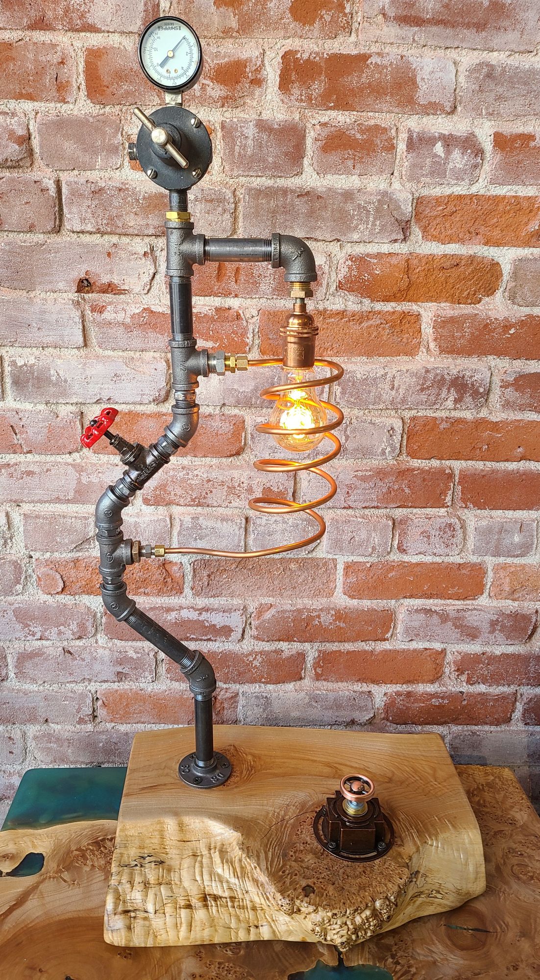 1/2" black iron pipe lamp with copper adjustable dimmer wheel, copper tubing and unique tool parts on 2" thick live edge maple burl base. 51" dark brown twisted cloth cord and plug. 40W Edison filament bulb.