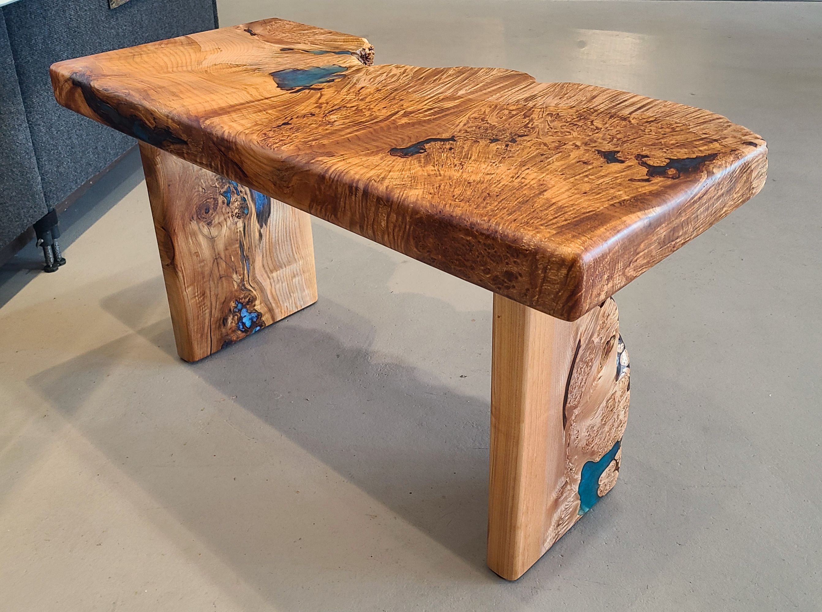 Maple Burl Bench. 2 1/2" thick with maple burl slab legs. Teal mica epoxy fill.