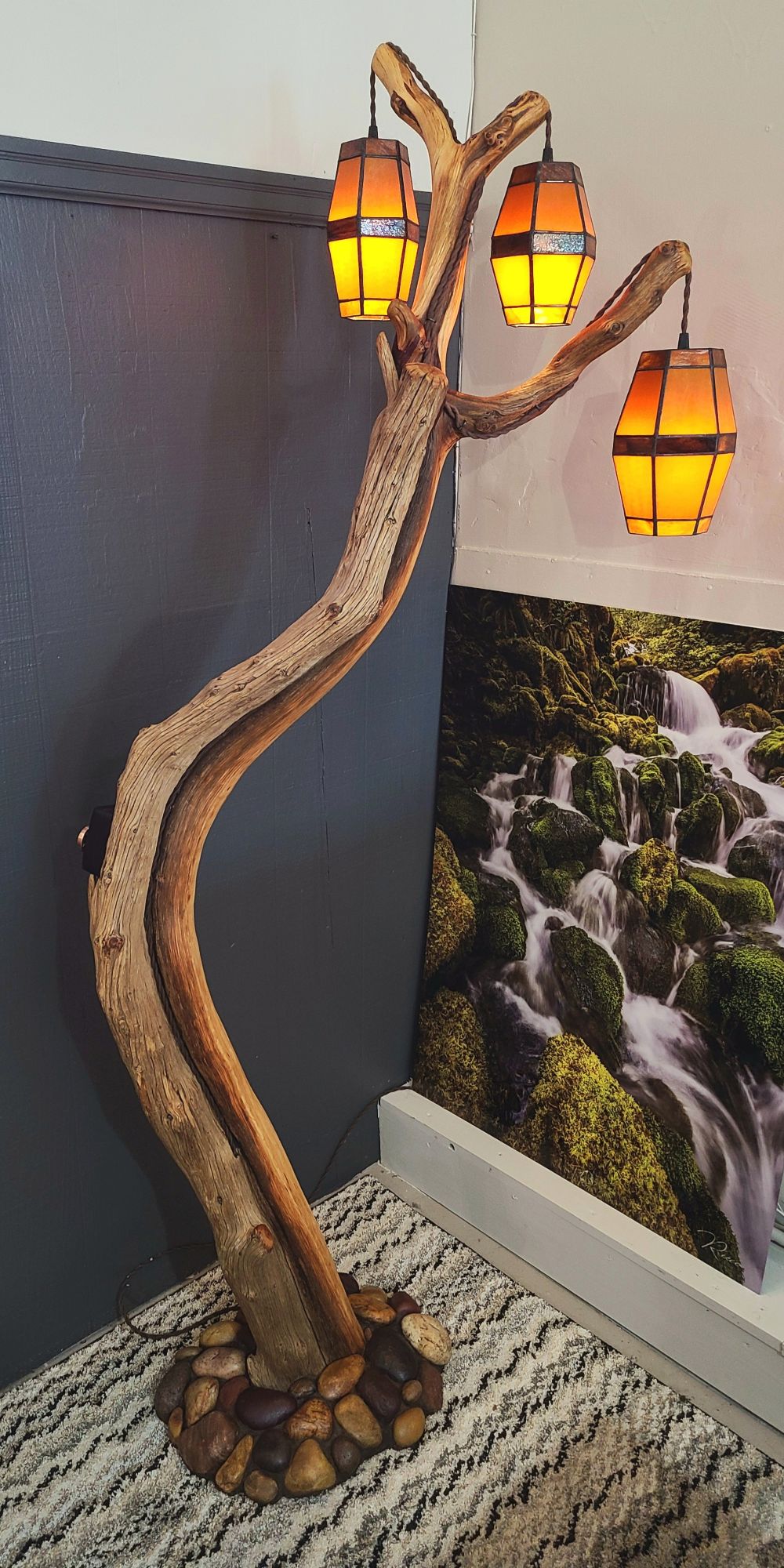 Juniper Floor Lamp with 3 Stained Glass Pendants and River Rock Base. Dimmer switch with copper wheel control. 65" Antique twisted cloth covered cord and plug. Tongue oil finish.