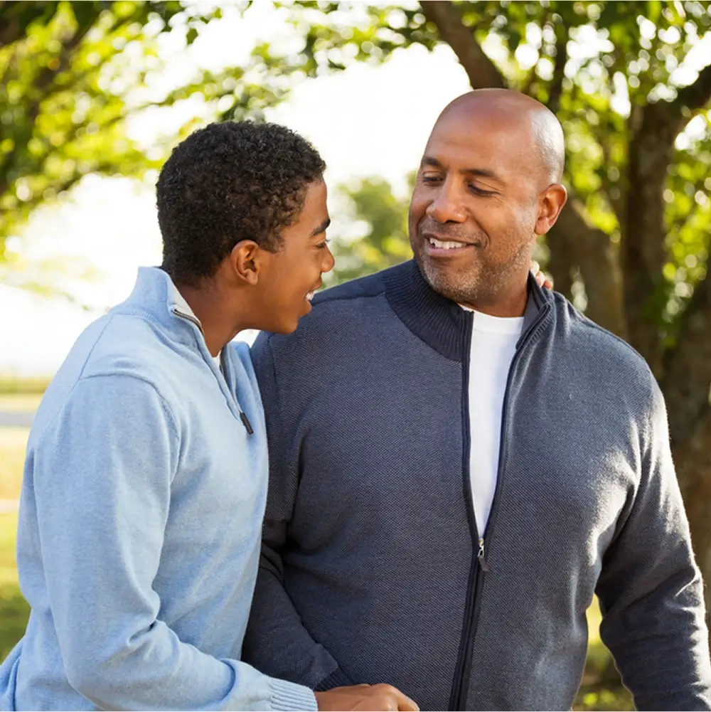 A father and his teenage son walk towards us, smiling and chatting. Self-funding your rehab can give you the best chance at recovery, and of spending more time with your loved ones.