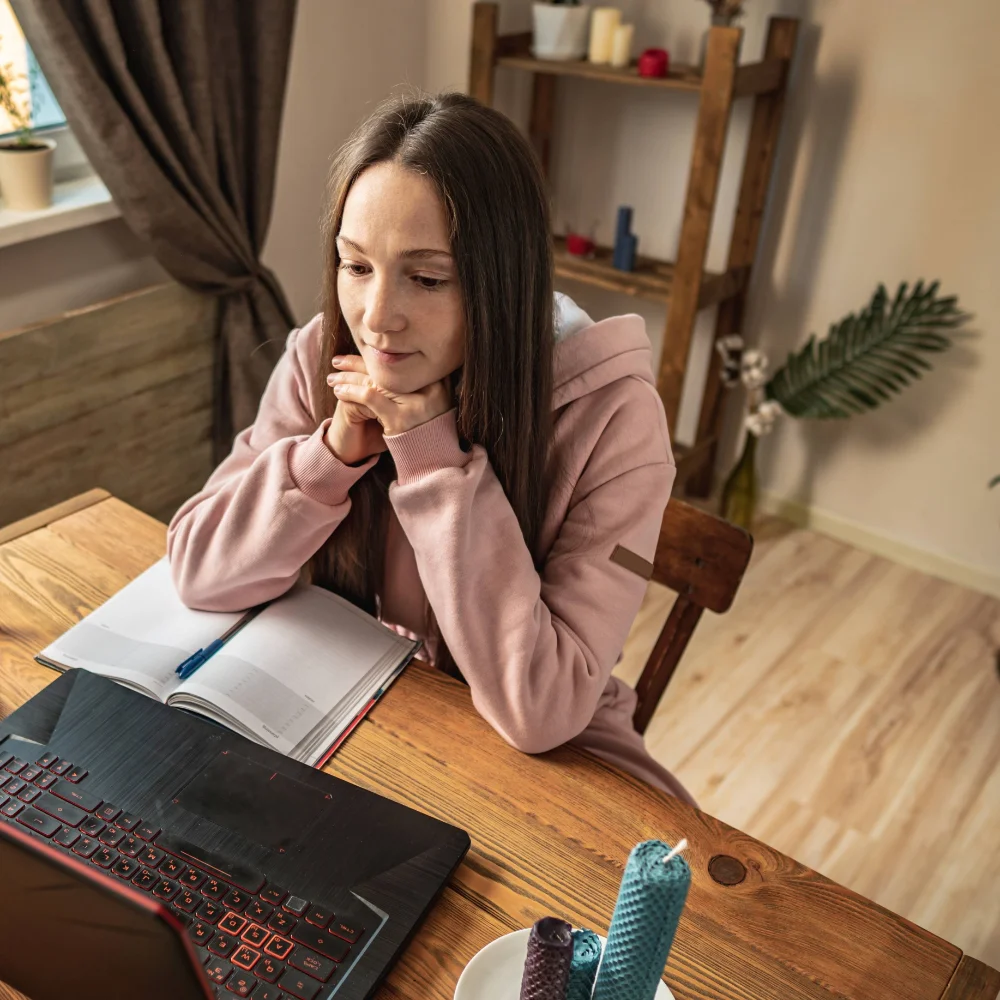 Woman participating in a virtual recovery session from home, engaging in structured therapy through the Hader at Home online rehab program