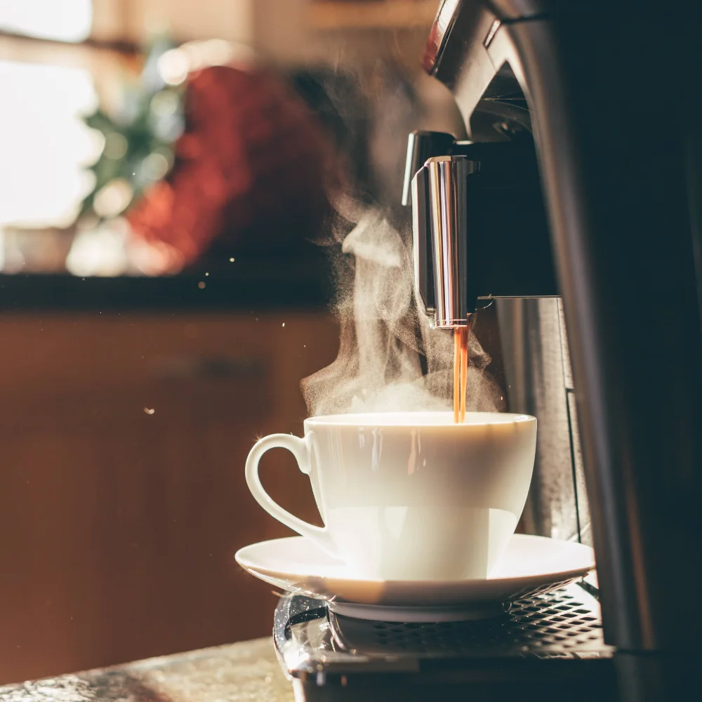 Fresh coffee brewing in a shared kitchen on an early morning, capturing the simple routines that support daily life and recovery in transitional housing.