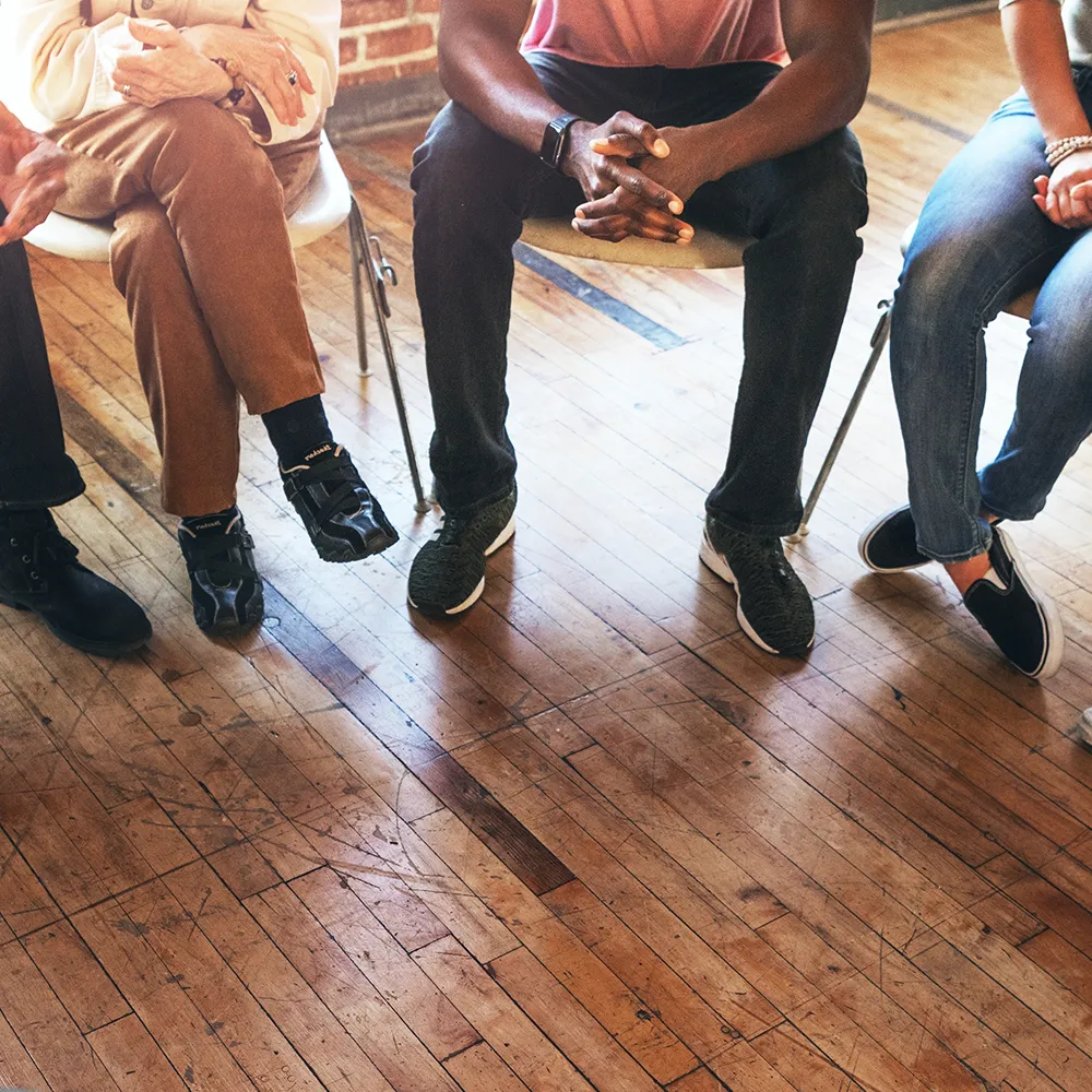 A diverse group of younger and older men and women in a group therapy session. If you have private health insurance with Bupa, it may make residential rehab more accessible.