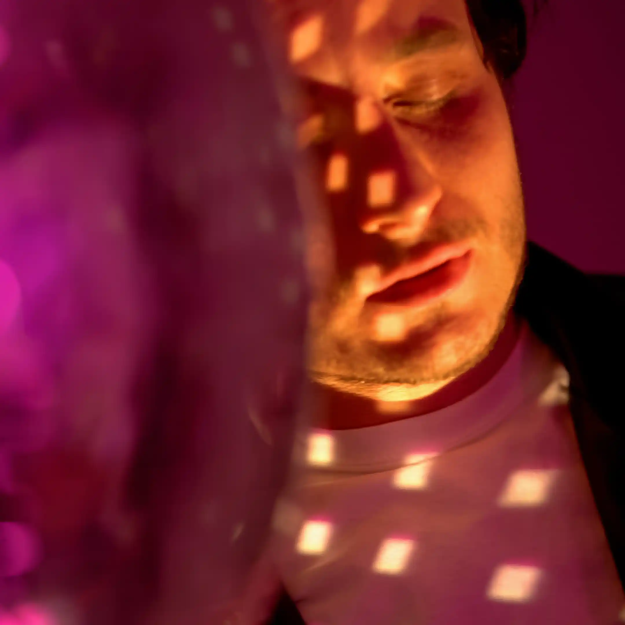 A person stands next to a disco ball in a dark club setting, reflecting the party lifestyle and social environments that can lead to marijuana addiction and the need for professional rehab support.