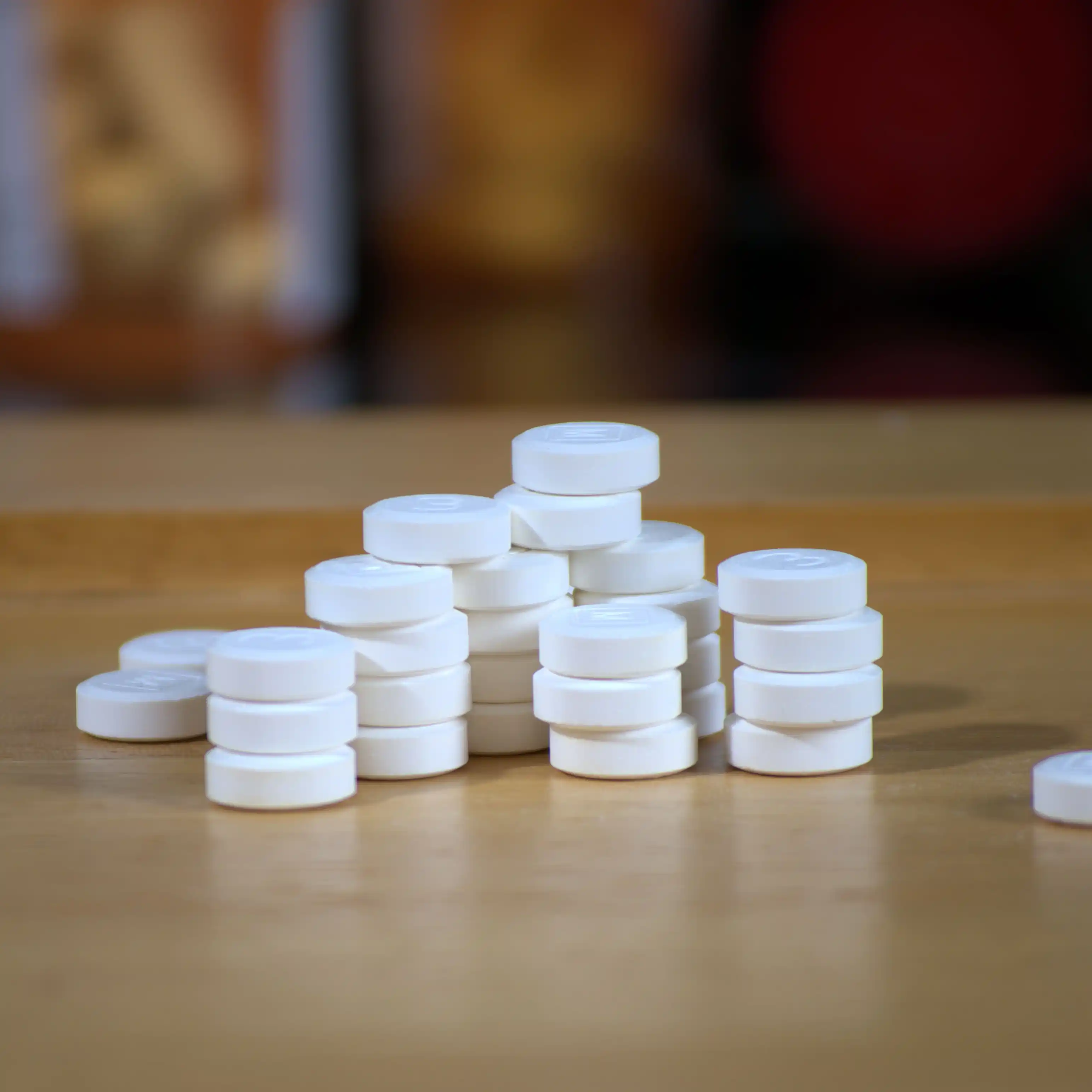 A stack of codeine tablets rests on table.