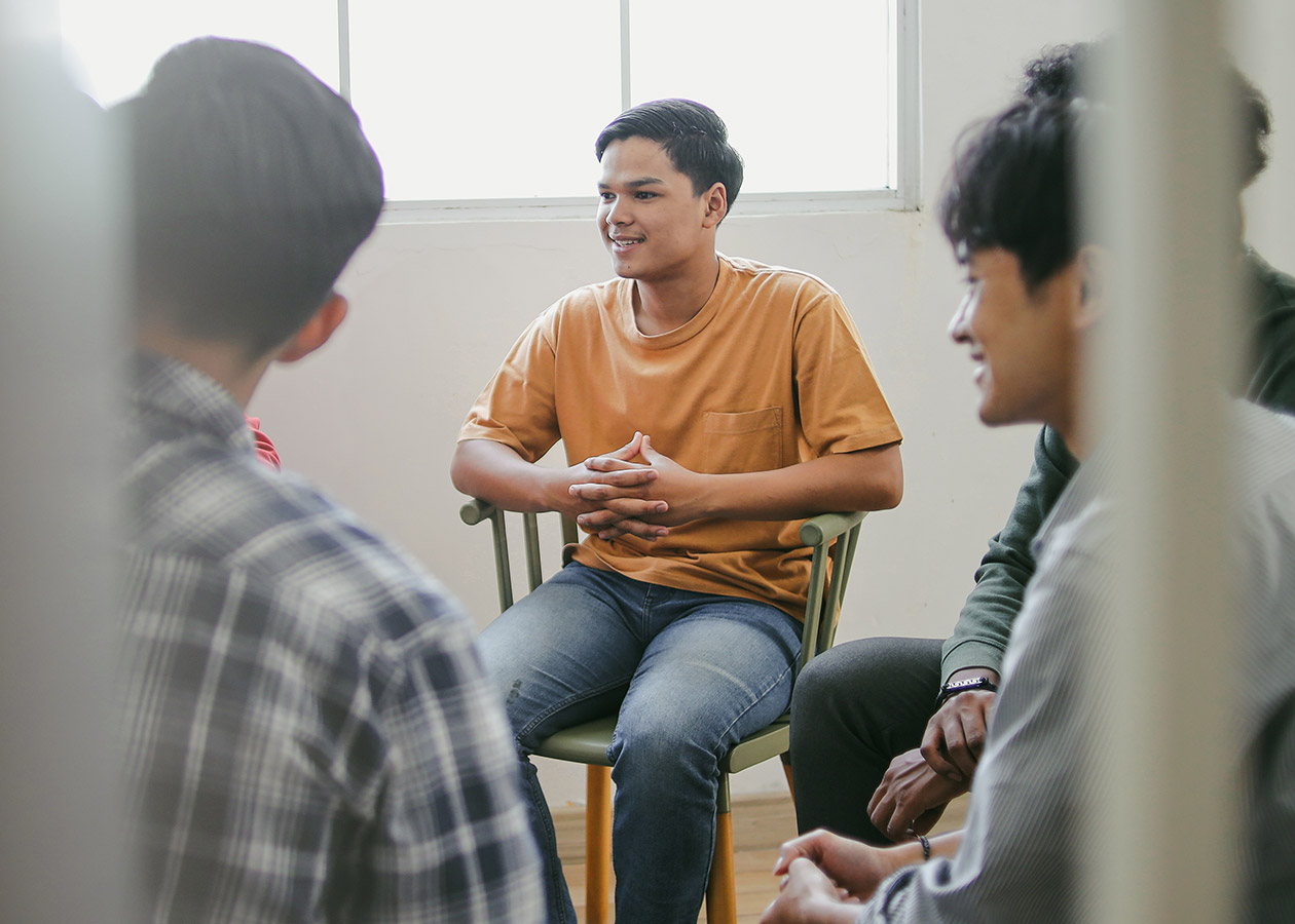 A group doing rehab for young adults in an indoor setting.