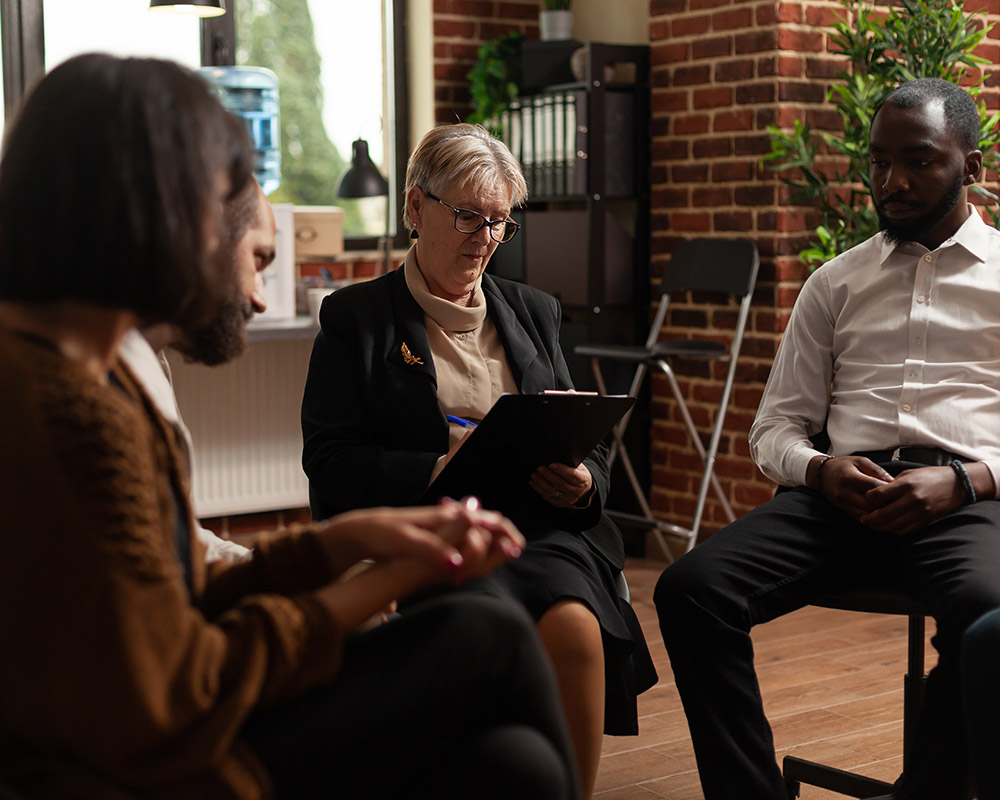 A therapist leading a session at Hader Clinic.