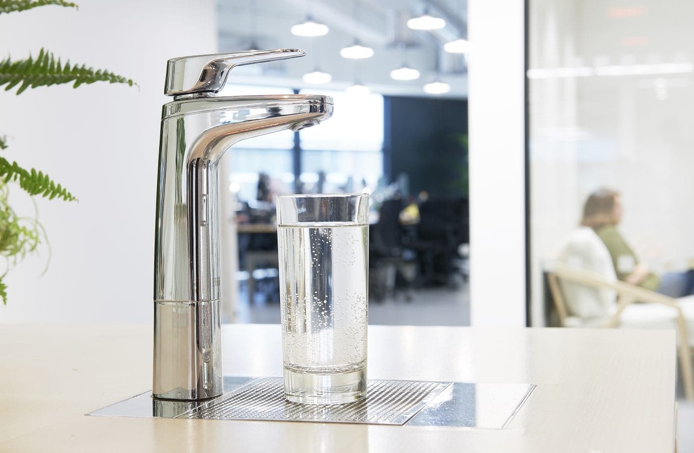 Chrome Billi XL levered dispenser with a glass of water in an office kitchen