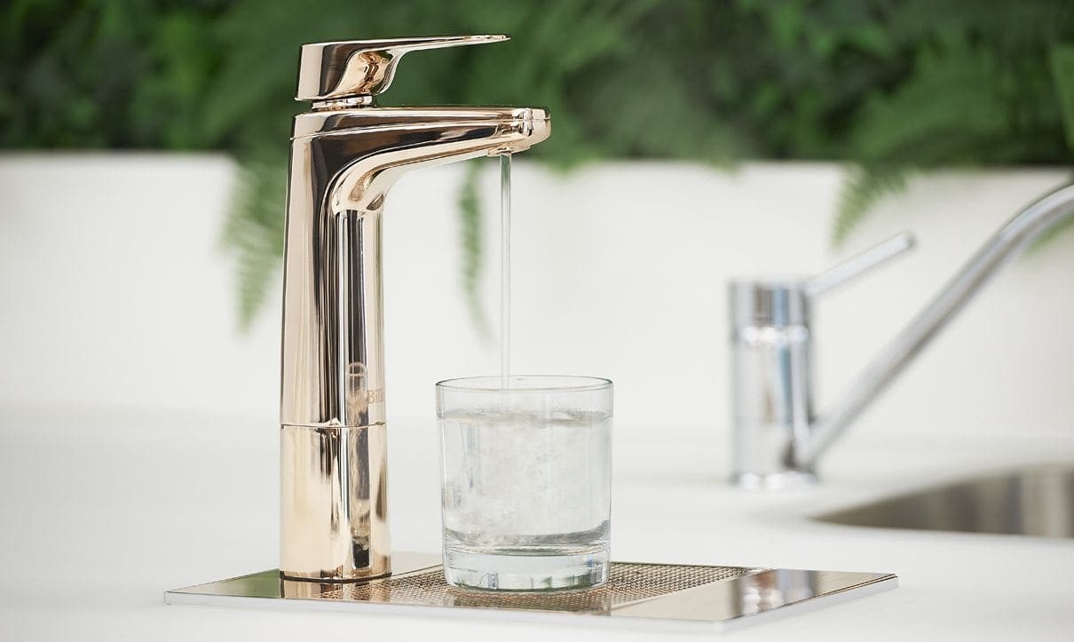 Billi XL levered dispenser pouring filtered water into a glass on a kitchen worktop