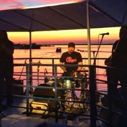 Live music being played on our Cruise For a Cause as the sun sets on a beautiful summer evening.