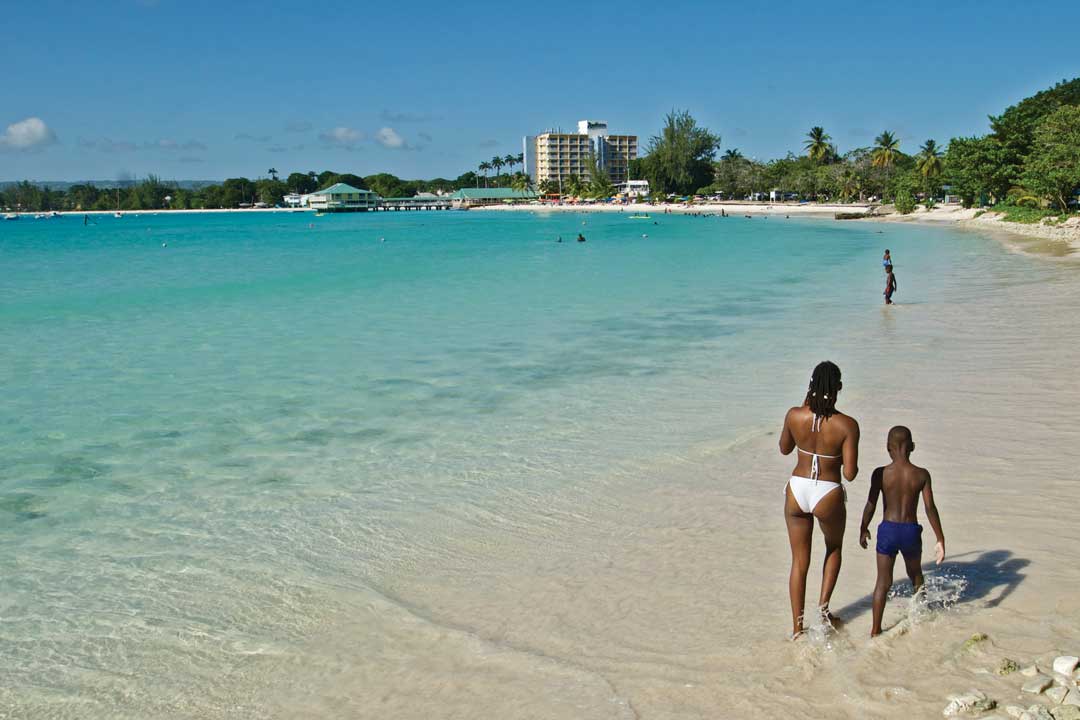 Mother and son walking along Pebbles Beach