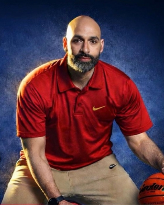 Eddie Rios in red polo with a basketball